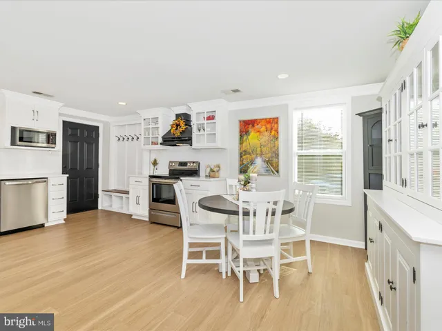 a dining room with furniture and a kitchen view