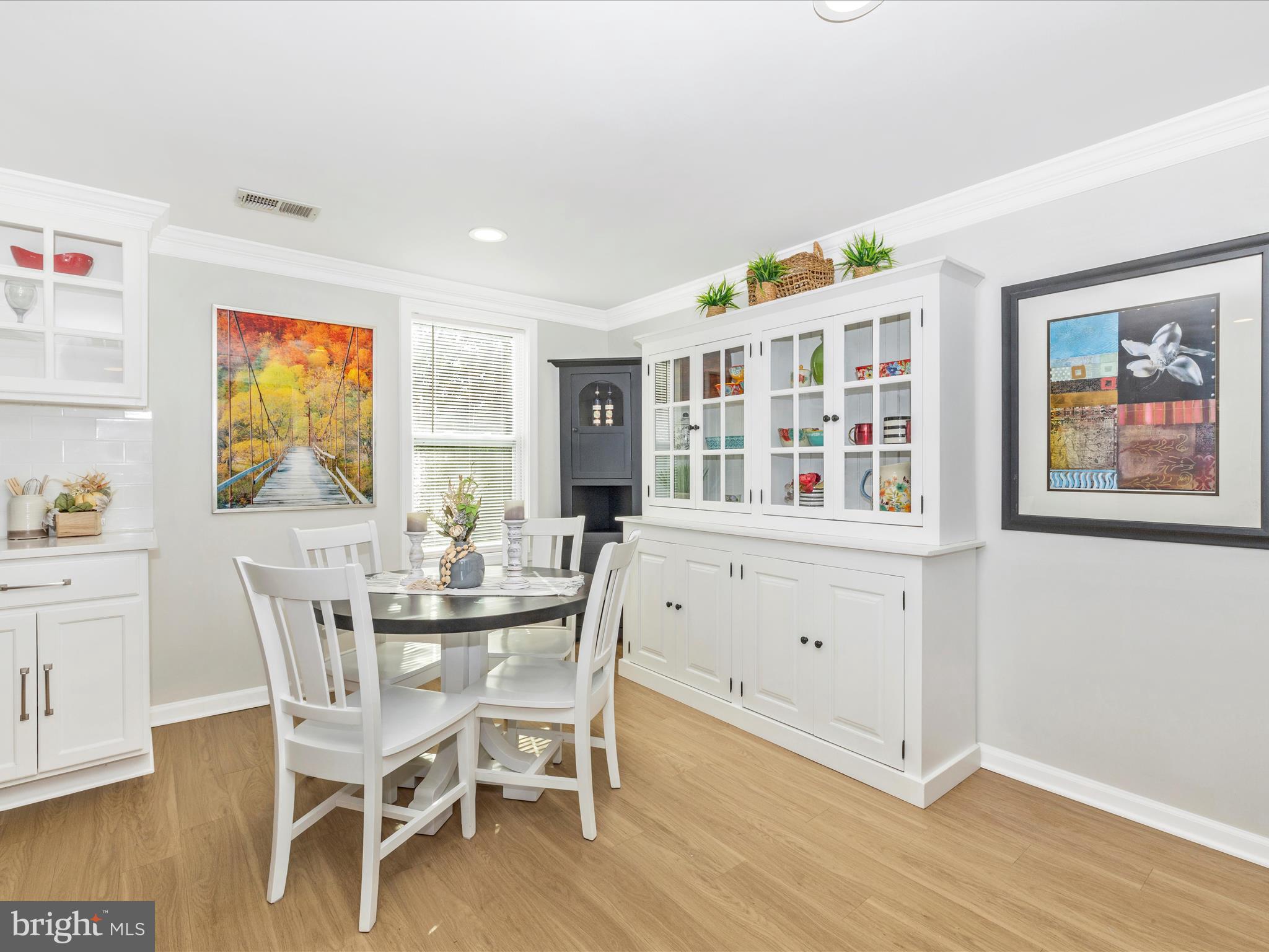 1410 Woodenbridge Lane Mount Airy, MD 21771 - Photo 10 of 50 a dining room with furniture a window and wooden floor