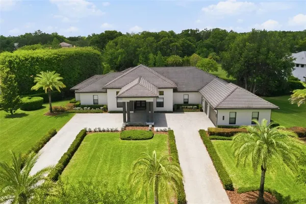 a view of house with garden space and a patio