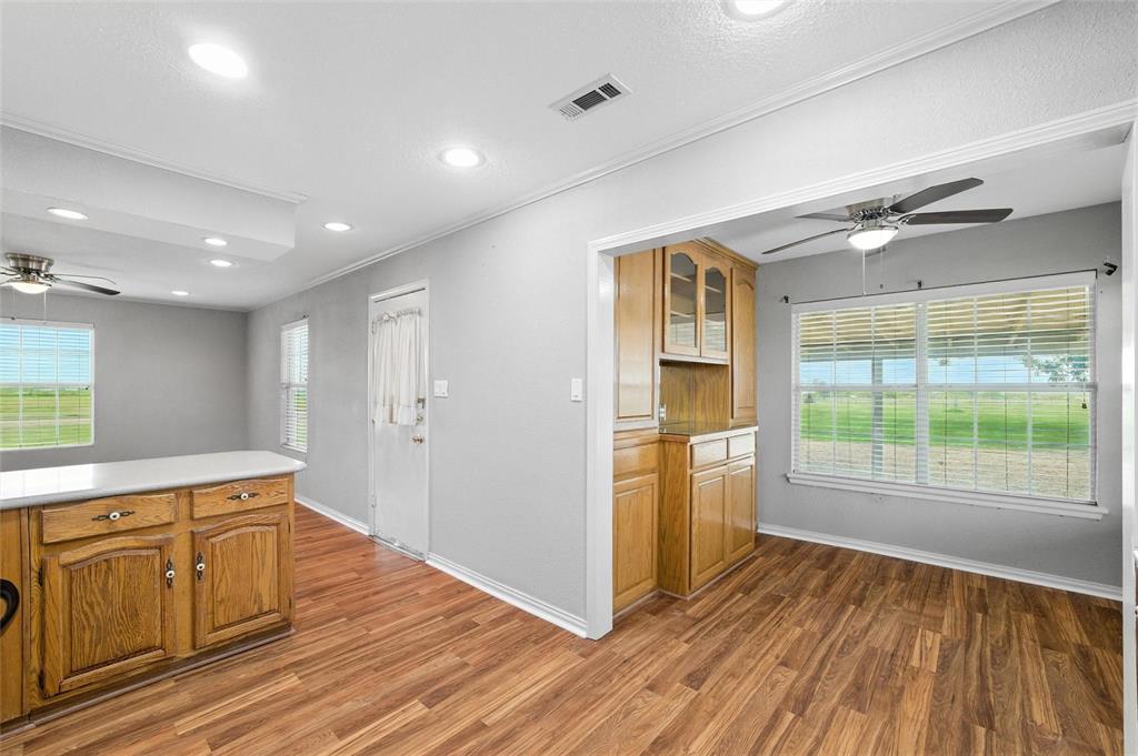 358 Wright Road Waxahachie, TX 75167 - Photo 23 of 38 a view of a kitchen with wooden floor and electronic appliances