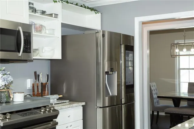 a kitchen with a refrigerator and a stove top oven