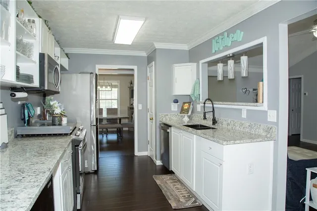 a kitchen with stainless steel appliances granite countertop a stove and a sink