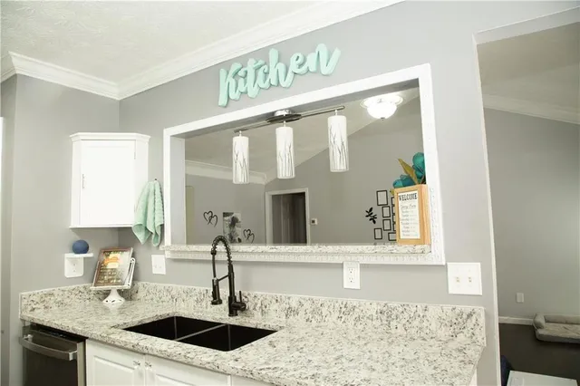 a kitchen with granite countertop a sink and a window