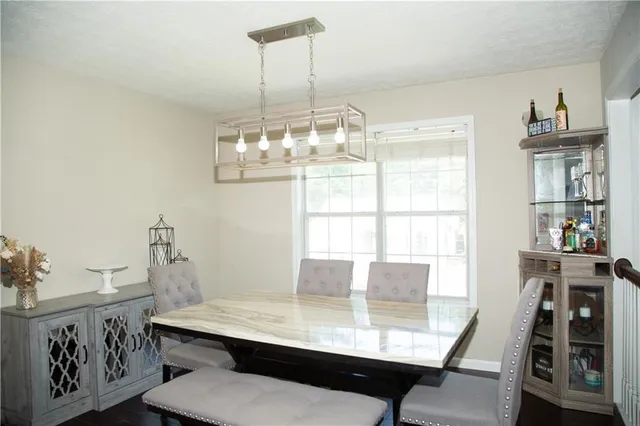 a view of a dining room with furniture window and outside view