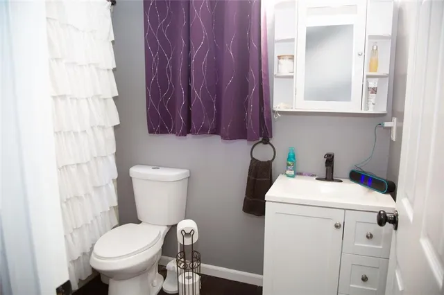 a white toilet sitting next to a bathroom sink
