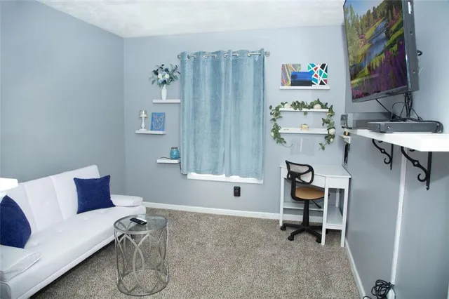 a living room with furniture a piano and a window