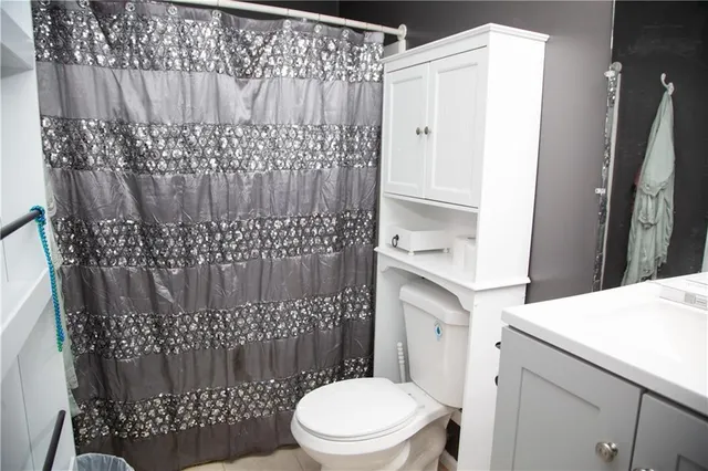 a bathroom with a toilet and a shower