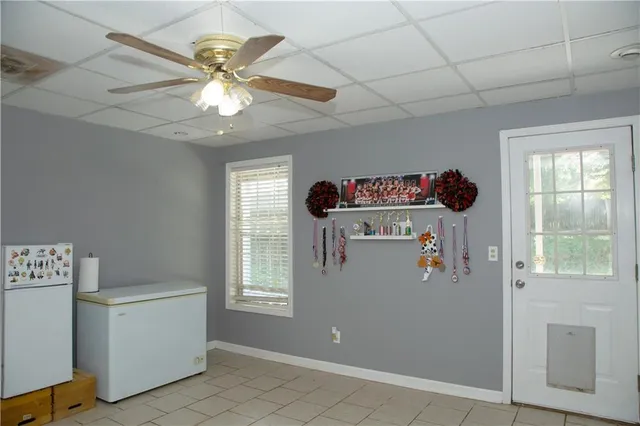 a room with a window and ceiling fan