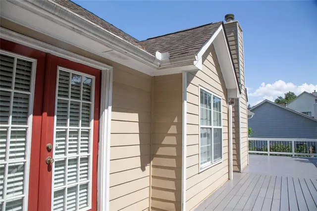 a view of a balcony with wooden floor and a potted plant