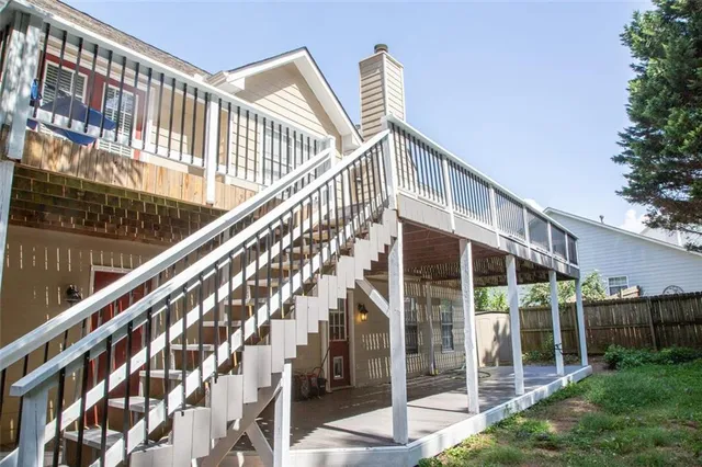 a view of staircase with railing and white walls