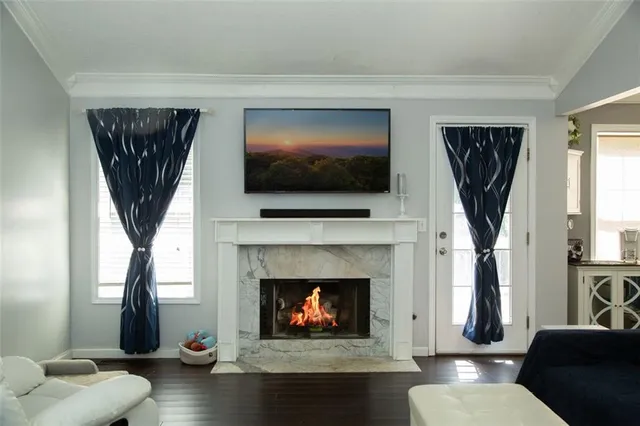 a living room with furniture a fireplace and a flat screen tv