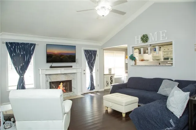 a living room with furniture a fireplace and a flat screen tv