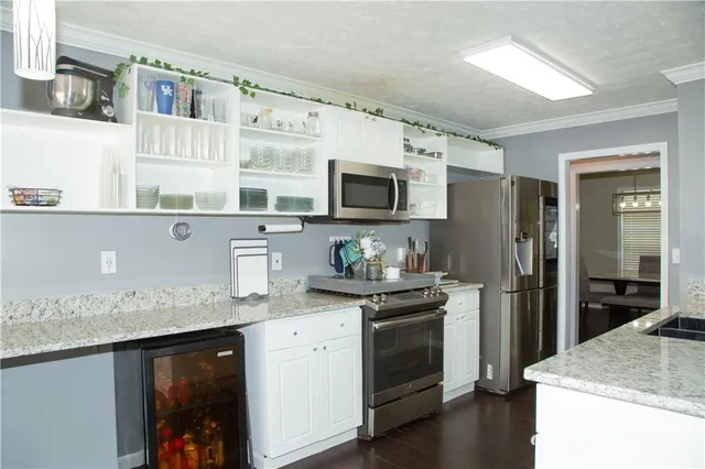 a kitchen with a sink stove and refrigerator
