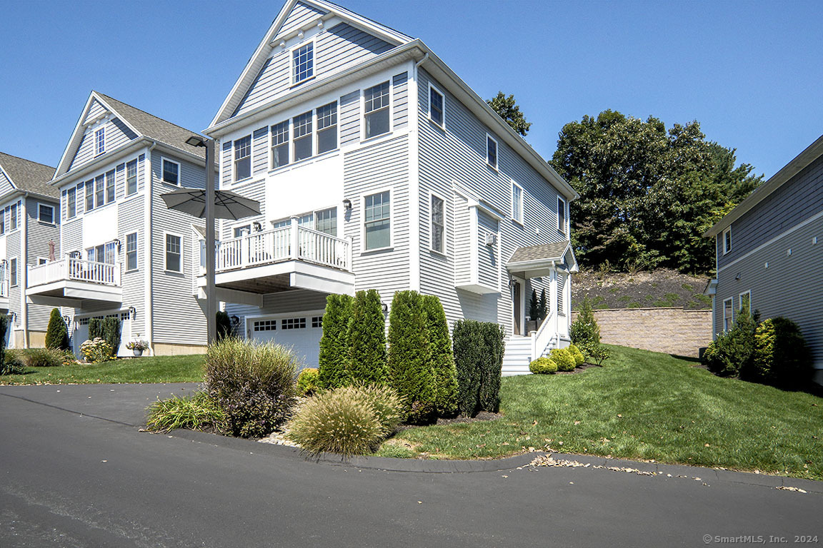 500 River Road, Unit 5 Shelton, CT 06484 - Photo 1 of 1 a front view of a house with a garden and plants