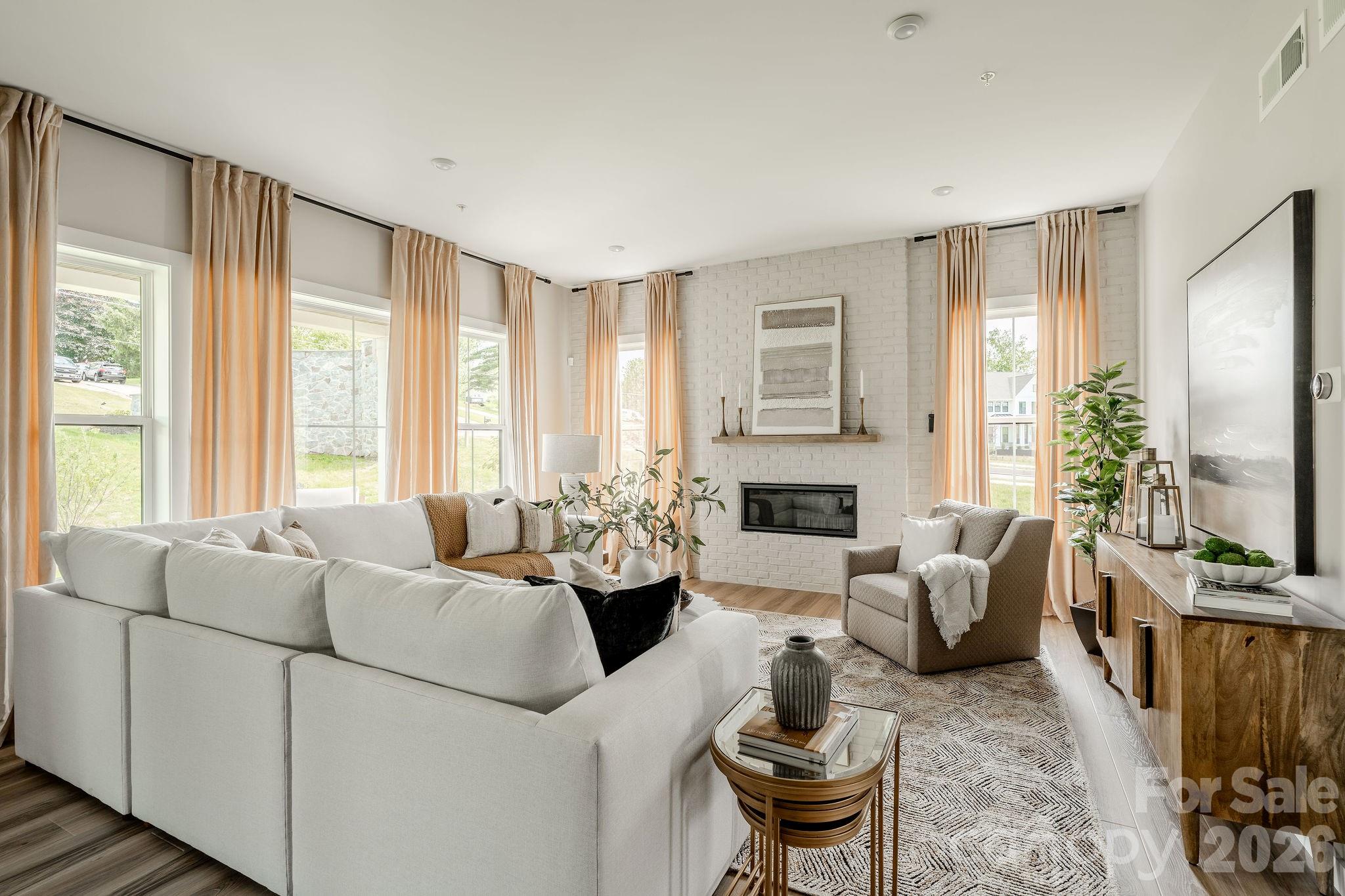 2 Pinnacle Way, Unit COVINGTON York, SC 29745 - Photo 20 of 46 a living room with furniture fireplace and a large window