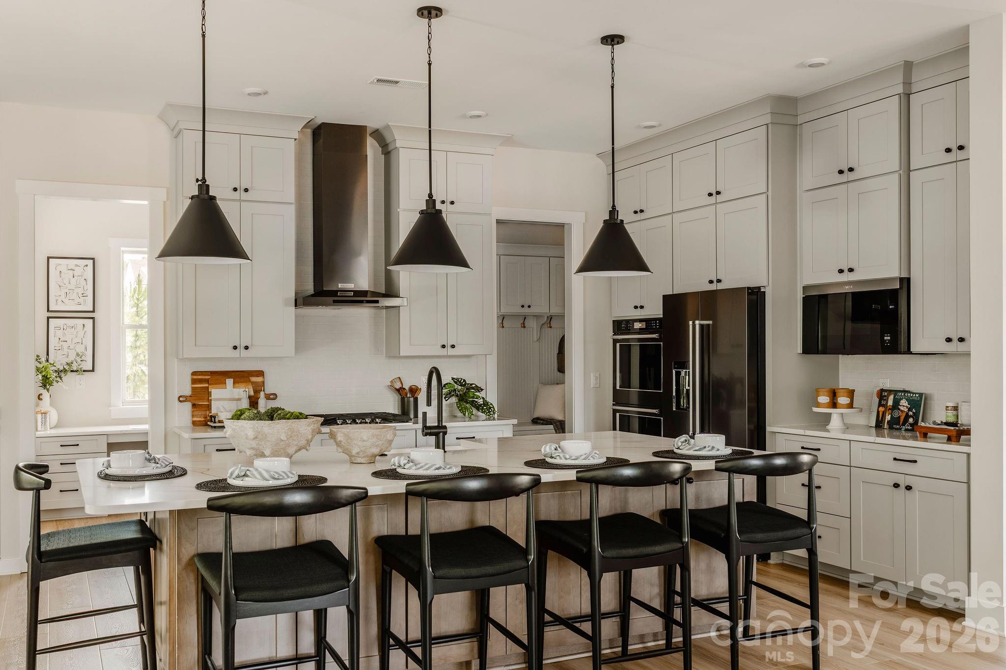 2 Pinnacle Way, Unit COVINGTON York, SC 29745 - Photo 10 of 46 a kitchen with stainless steel appliances kitchen island granite countertop a table chairs in it and white cabinets