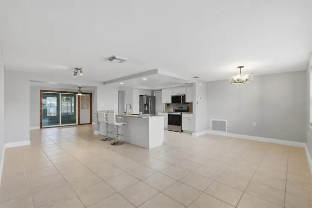 a kitchen with stainless steel appliances kitchen island granite countertop a sink and cabinets