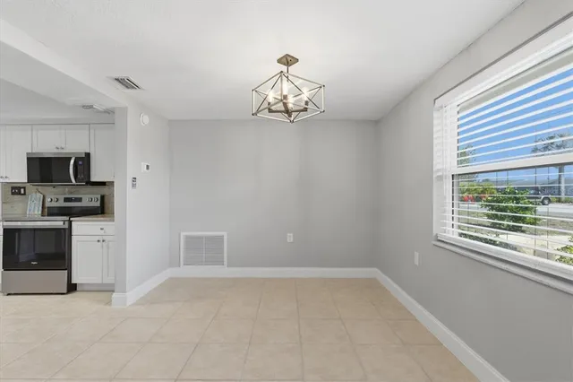 a kitchen with cabinets stainless steel appliances and sink
