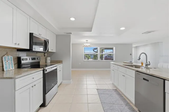 a view of a room with wooden floor and a ceiling fan