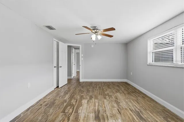 wooden floor in an empty room with a window