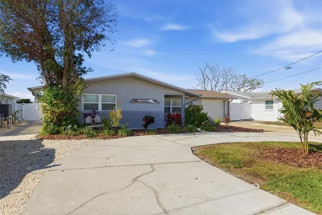 a front view of house with yard and trees around