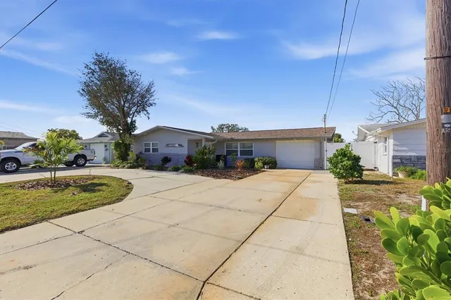 a front view of a house with plants