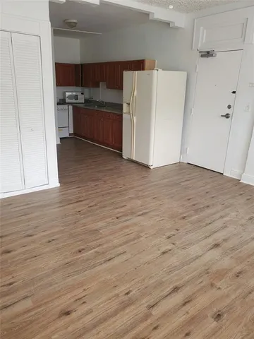 a view of kitchen with cabinets and wooden floor