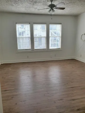 a view of room with window and wooden floor