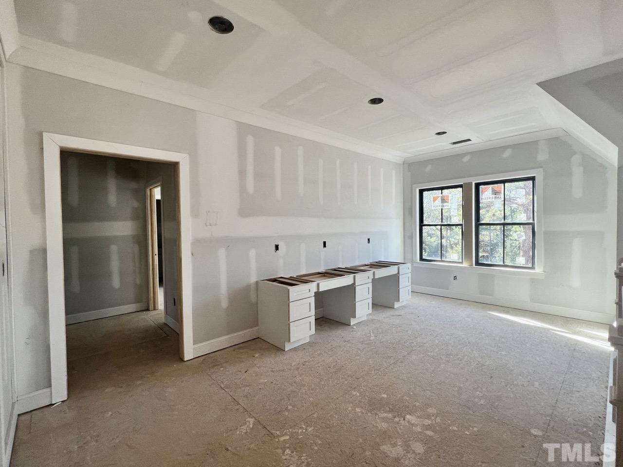 5011 Ten-Ten Road Apex, NC 27539 - Photo 33 of 49 an empty room with windows and cabinet