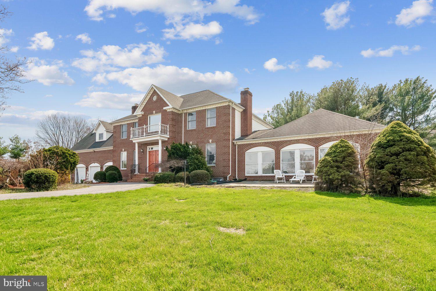 a front view of house with yard and green space