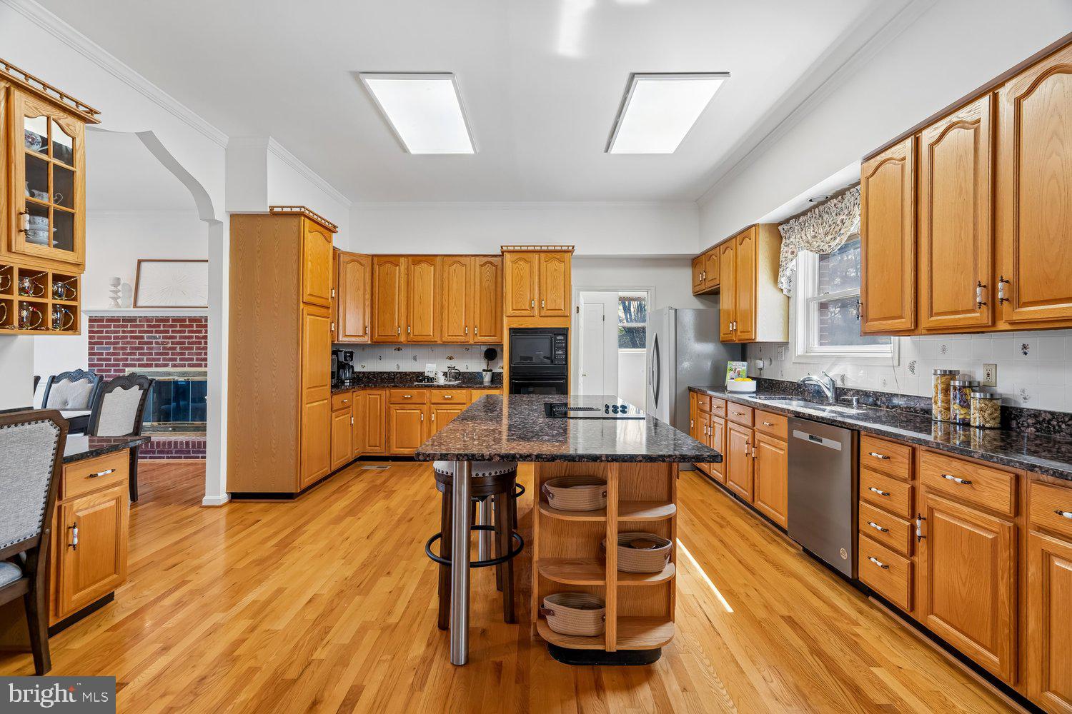 2950 Hobbs Road Glenwood, MD 21738 - Photo 16 of 82 a kitchen with stainless steel appliances wooden floors and wooden cabinets