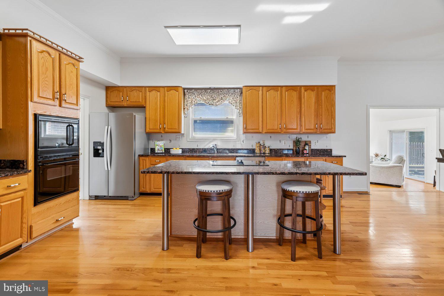 2950 Hobbs Road Glenwood, MD 21738 - Photo 17 of 82 a kitchen with granite countertop a stove a sink and a refrigerator