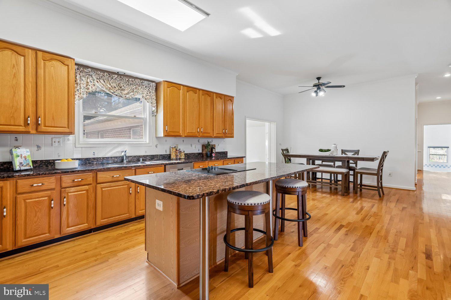 2950 Hobbs Road Glenwood, MD 21738 - Photo 18 of 82 a kitchen with a sink cabinets and dining table chair