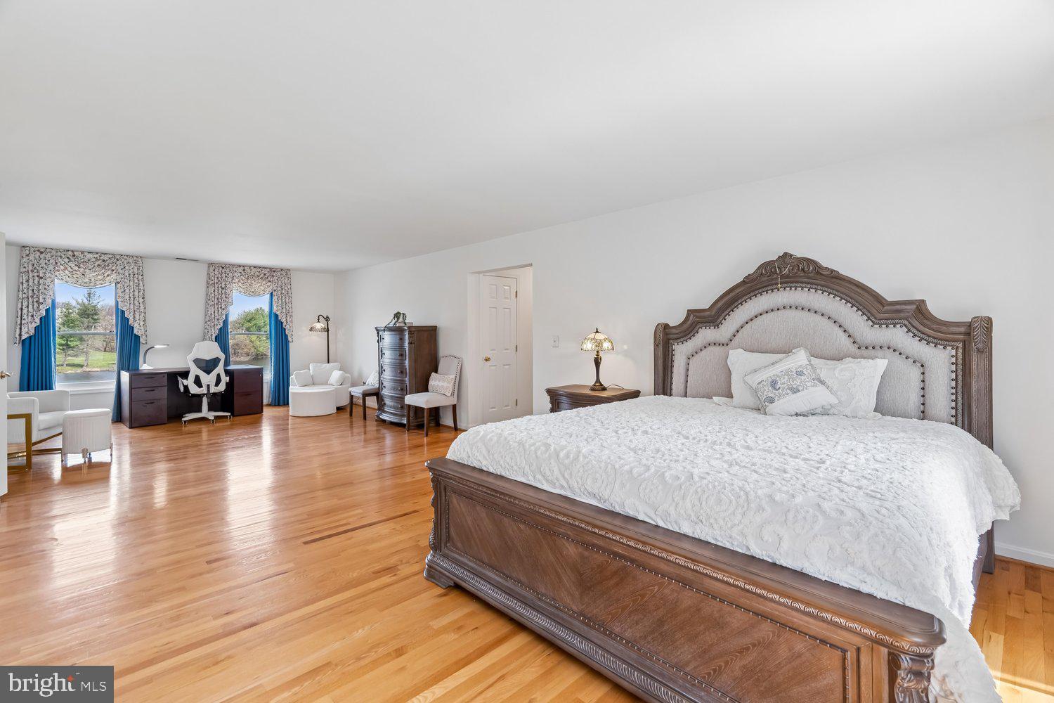 2950 Hobbs Road Glenwood, MD 21738 - Photo 31 of 82 a spacious bedroom with bed and wooden floor
