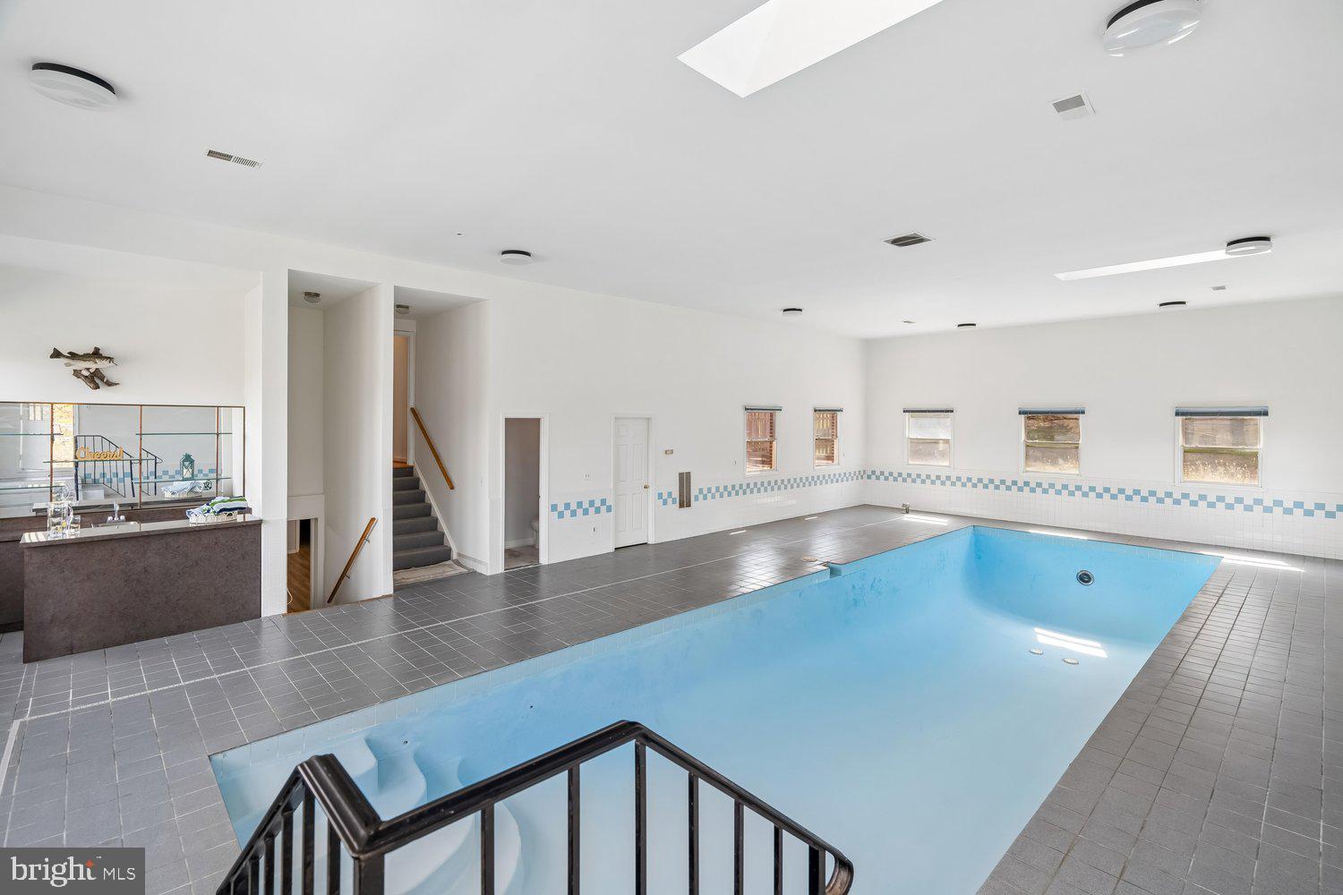 2950 Hobbs Road Glenwood, MD 21738 - Photo 50 of 82 a view of a kitchen with kitchen island a sink wooden floor and a counter top space