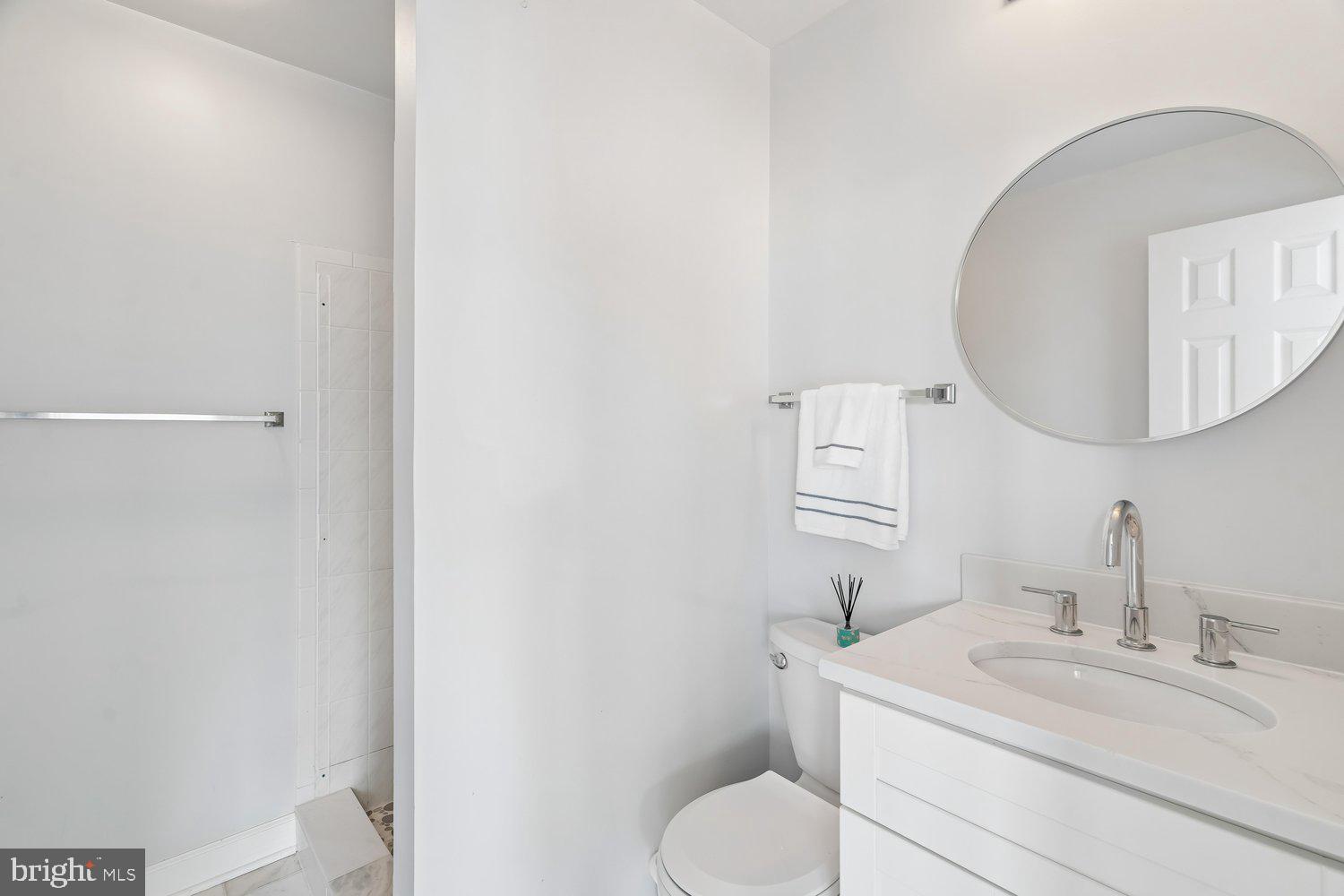 2950 Hobbs Road Glenwood, MD 21738 - Photo 54 of 82 a bathroom with a toilet a sink and mirror