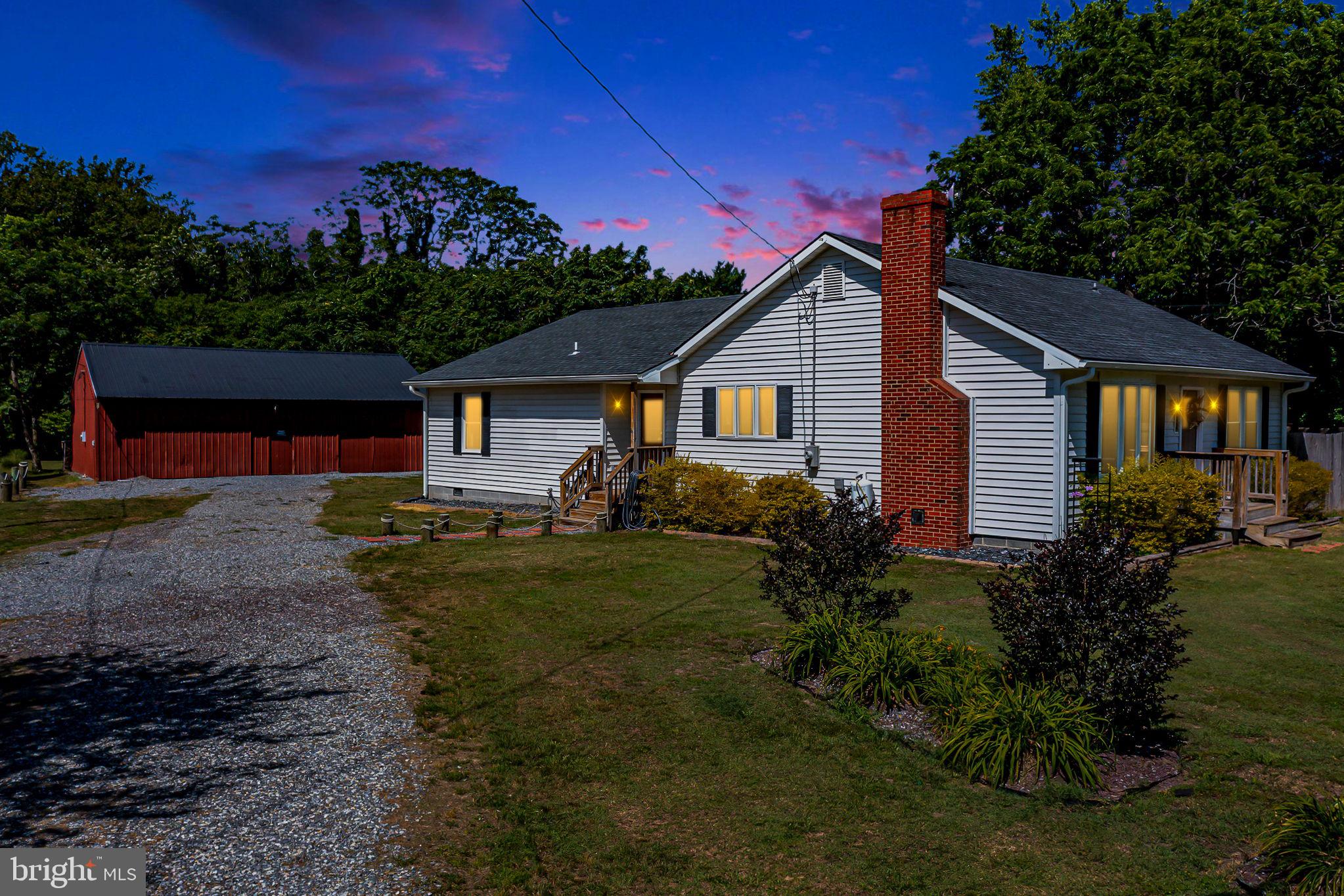 9832 River Road Lancaster, VA 22503 - Photo 2 of 68 Charming home under a twilight sky.