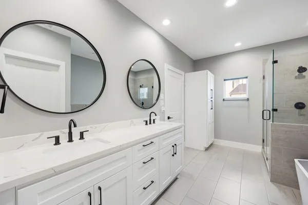 a bathroom with a bathtub and shower