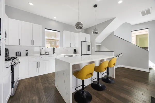 a kitchen with stainless steel appliances kitchen island a island in the center
