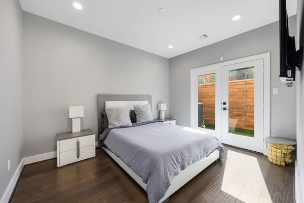 a bedroom with a large bed and a window
