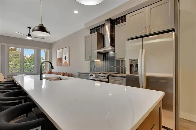 a living room with furniture and large windows