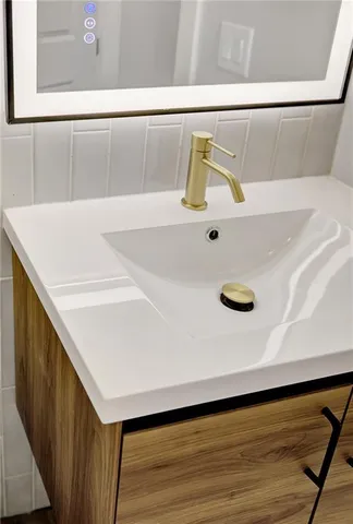 a bathroom with a sink and mirror