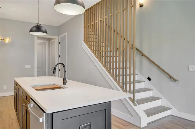 a view of a hallway with wooden floor and entryway