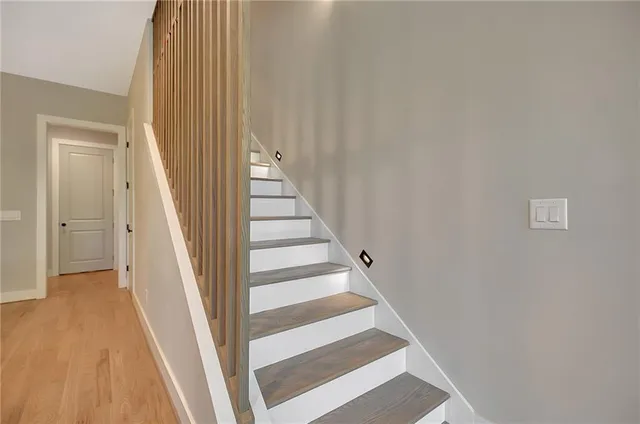 a spacious bedroom with a bed and a large window