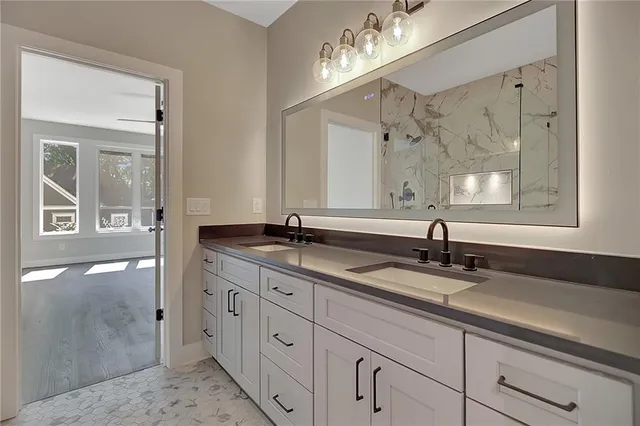 a bathroom with a granite countertop sink mirror and double