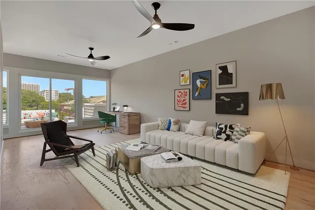 a living room with furniture and a potted plant