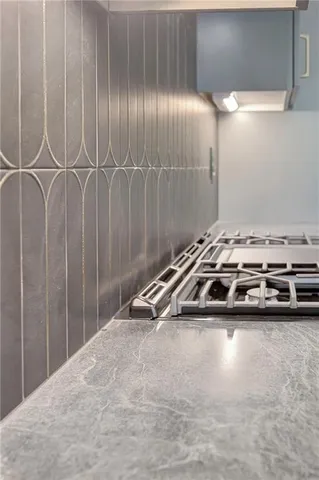 a kitchen with a sink and wooden floor