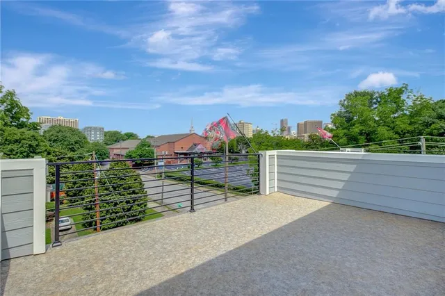 a view of a big house with a big yard and large trees