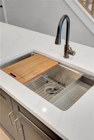 a kitchen with kitchen island a sink and wooden floor