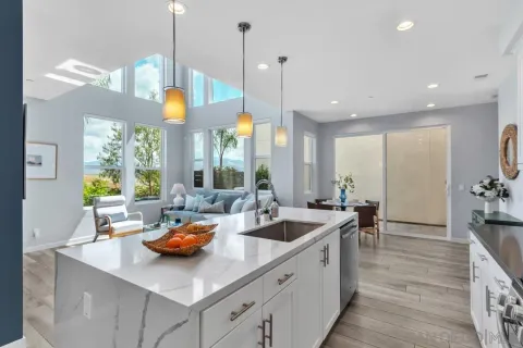 a kitchen with counter space and living room